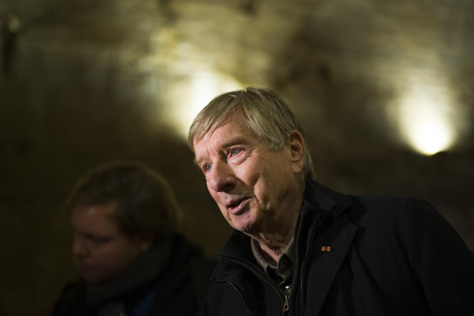 Ulrich Pfeifer how helped to dig an escape tunnel, underneath the Berlin Wall which divided the city for 28 years during the Cold War, and was make visible for public for the first time, talks to media in Berlin, Germany, Thursday, Nov. 7, 2019.The tunnel was built by a group of people who had escaped earlier from communist East Germany to West Berlin. They wanted to help friends and family to flee to the West, too, but days before it was finished, East German officials discovered and destroyed it. (AP Photo/Markus Schreiber)