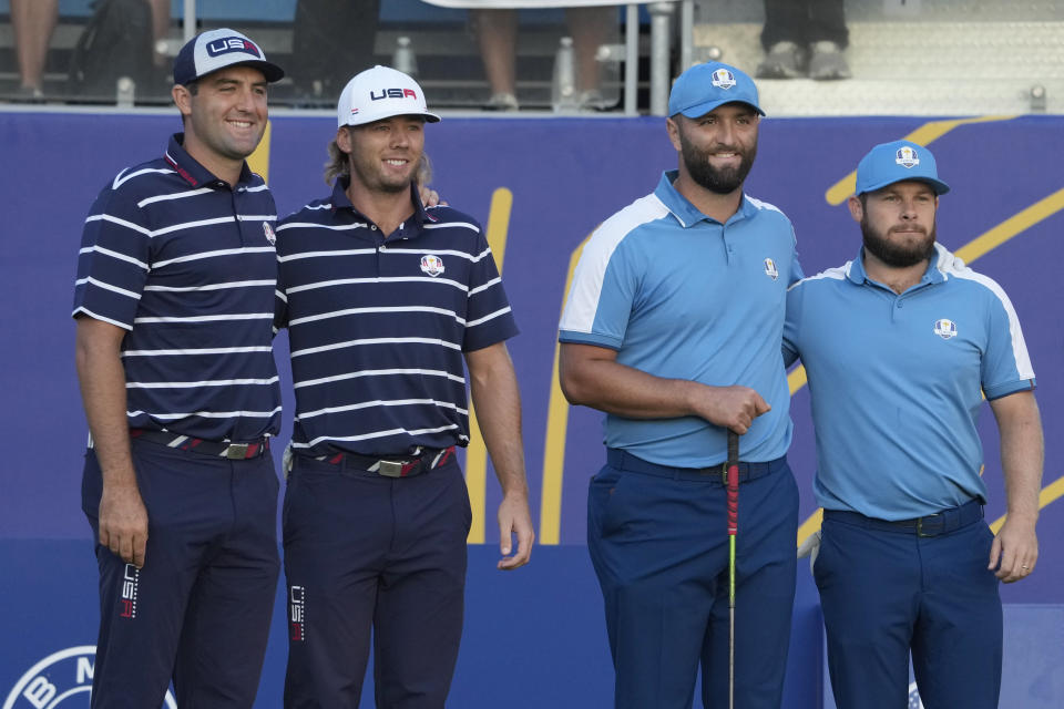 United States' Scottie Scheffler, left, with teammate United States' Sam Burns play against Europe's Jon Rahm and Europe's Tyrrell Hatton, right, in the first morning Foursome match pose for a photograph at the Ryder Cup golf tournament at the Marco Simone Golf Club in Guidonia Montecelio, Italy, Friday, Sept. 29, 2023. (AP Photo/Andrew Medichini)