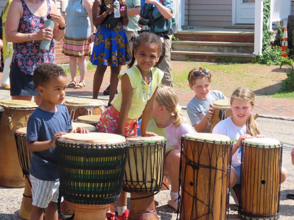 Children participate in an African drumming workshop before the Akwaaba Ensemble performance during Portsmouth's Juneteenth celebration at the African Burying Ground Wednesday, June 19, 2024.