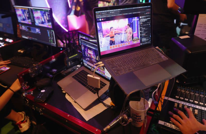 Crew members monitor the live streaming of a getai show on social media platforms at a studio in Singapore