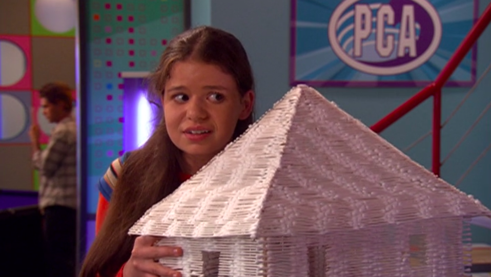 Stacey holding up a house made of cotton swabs