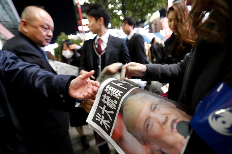 Mandatory Credit: Photo by Aflo/REX/Shutterstock (7427223k) A newspaper staff hands out an extra edition in downtown Tokyo announcing Donald Trump's election as the 45th president of the United States of America Reaction to the US presidential election results, Tokyo, Japan - 09 Nov 2016