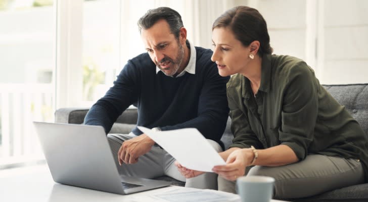 A married couple look over their portfolio and talks about their long-term investment strategy. 