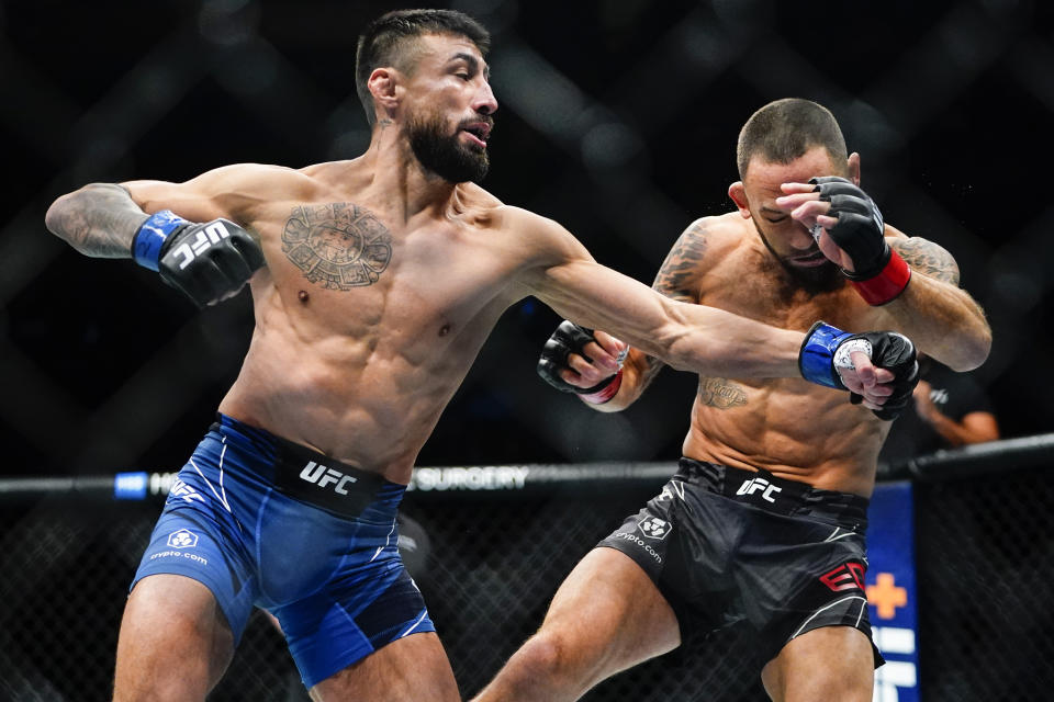 Chris Gutierrez, left, punches Frankie Edgar during the first round of a bantamweight bout at the UFC 281 mixed martial arts event Saturday, Nov. 12, 2022, in New York. Gutierrez stopped Edgar in the first round. (AP Photo/Frank Franklin II)