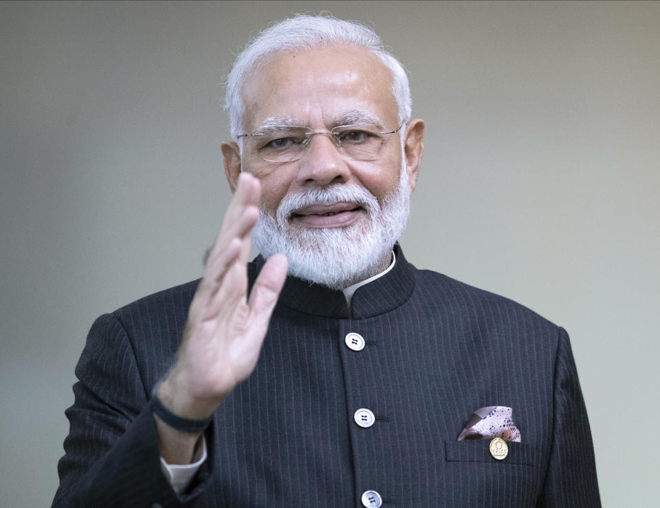 India's Prime Minister Narendra Modi greets the media prior to a meeting of leaders of the BRICS emerging economies at the Itamaraty palace in Brasilia, Brazil, Thursday, Nov. 14, 2019. (AP Photo/Pavel Golovkin, Pool)