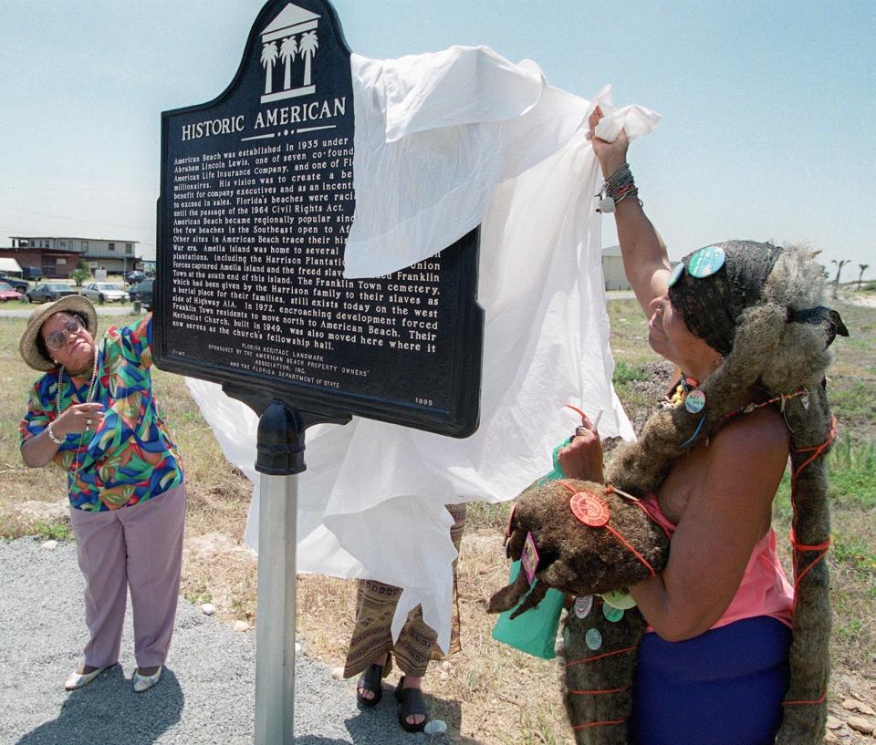 Emma Morgan (left), a property owner at American Beach and the late MaVynee Betsch, great-granddaughter of American Beach founder, unveil the historic marker on Lewis Street for the 65th anniversary in 2000.