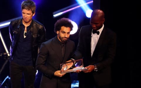 Liverpool's Mohamed Salah is presented with the Fifa Puskas award by Noel Gallagher and Didier Drogba - Credit: John Sibley/Reuters