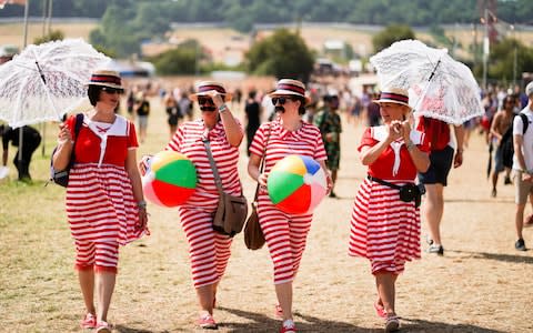 Although many people stripped off to try and stay cool, others had their costumes and they were sticking to them - Credit: Henry Nicholls/Reuters