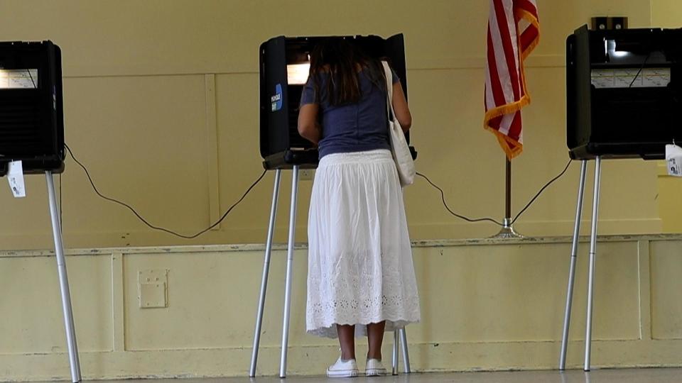 A woman votes at the polls in Florida. Florida's Supreme Court made a ruling that allows a six-week abortion ban to go into effect, but voters get to weigh in on the issue on the ballot.