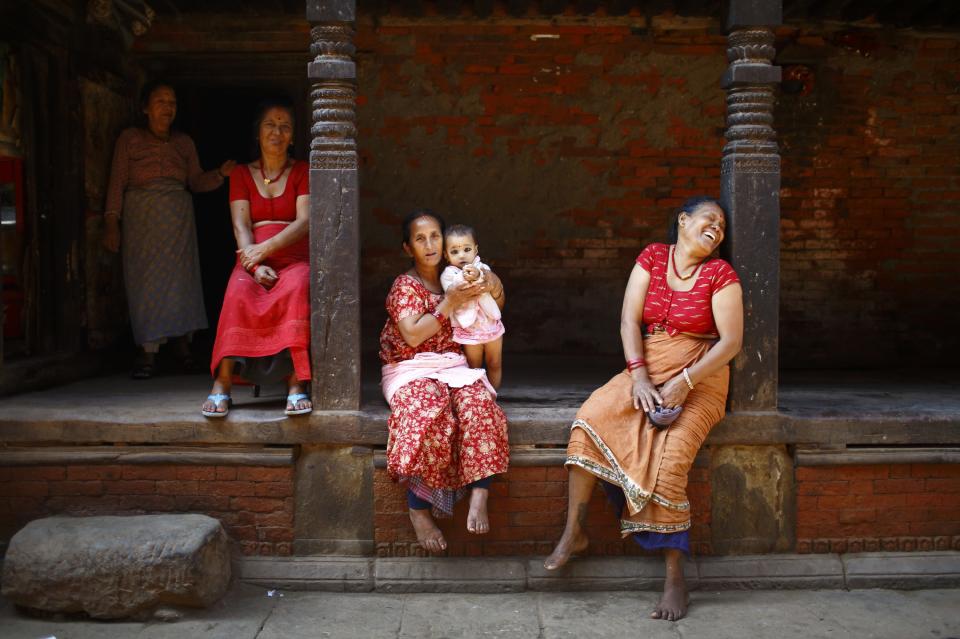 Women sit outside a house along the streets at the ancient city of Bhaktapur, near Nepal's capital Kathmandu September 23, 2013. (REUTERS/Navesh Chitrakar)