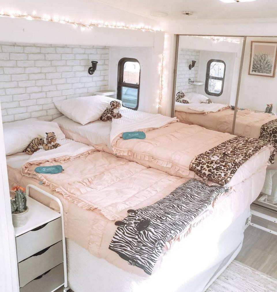 The bedroom with two beds and a closet in the back inside April Gilleland&#39;s RV