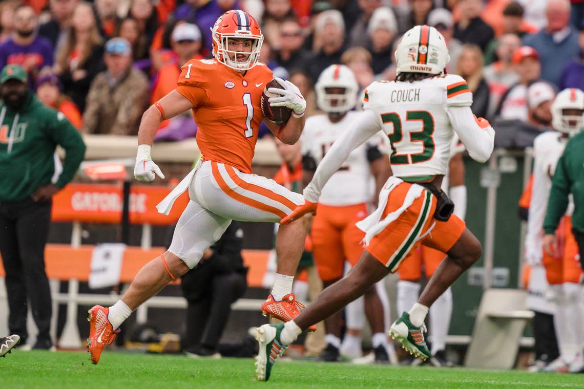 Miami cornerback Te’Cory Couch (23) defends against Clemson running back Will Shipley (1) during an NCAA college football game on Saturday, Nov. 19, 2022, in Clemson, S.C. (AP Photo/Jacob Kupferman)
