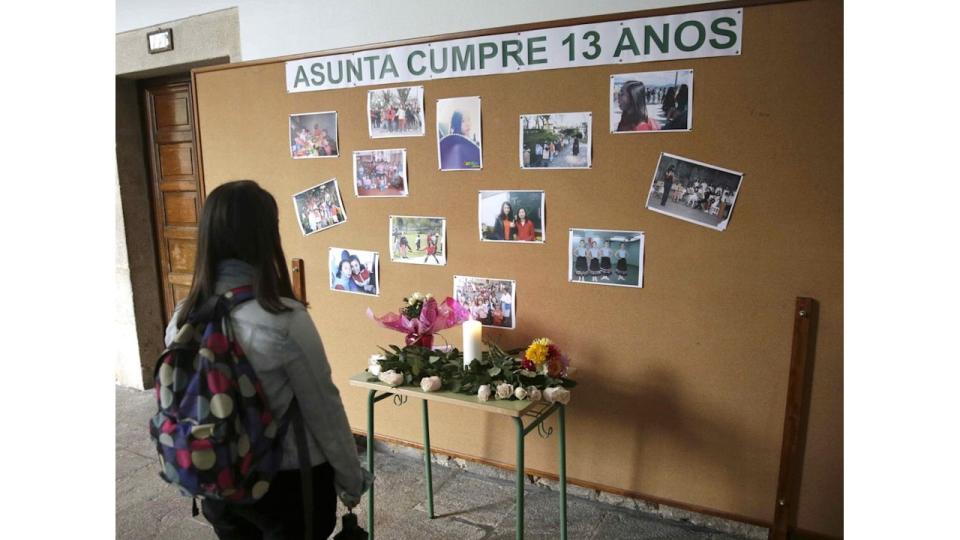 A Girl Looks the Mural with pictures of Asunta Basterra the 12-year-old girl