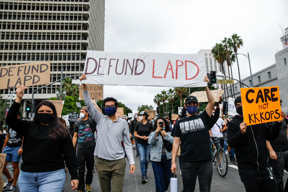 A variety of signs, including Defund LAPD, were held high, among about 1,000 people gathered to protest the death of George Floyd and in support of Black Lives Matter, in downtown, Los Angeles, CA, on Friday, June 5, 2020. (Jay L. Clendenin/Los Angeles Times via Getty Images)
