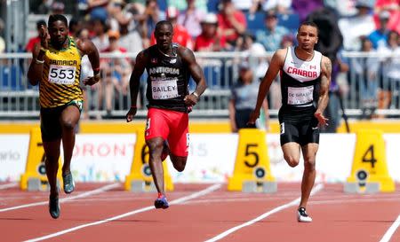 Jul 21, 2015; Toronto, Ontario, CAN; From left Jason Livermore of Jamaica , Daniel Bailey of Antigua and Andre De Grasse of Canada race in a men's athletics 100m preliminary heat during the 2015 Pan Am Games at CIBC Pan Am Athletics Stadium. Erich Schlegel-USA TODAY Sports