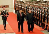 Kim and Xi inspect a guard of honour