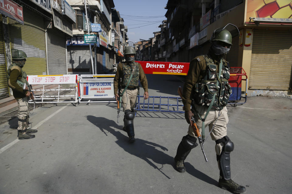 Indian paramilitary guard a temporary checkpoint in Srinagar, Indian controlled Kashmir,Monday, Oct. 22, 2018. Armed soldiers and police have fanned out across much of Indian-controlled Kashmir as separatists challenging Indian rule called for a general strike to mourn the deaths of civilians and armed rebels during confrontation with government forces. (AP Photo/Mukhtar Khan)