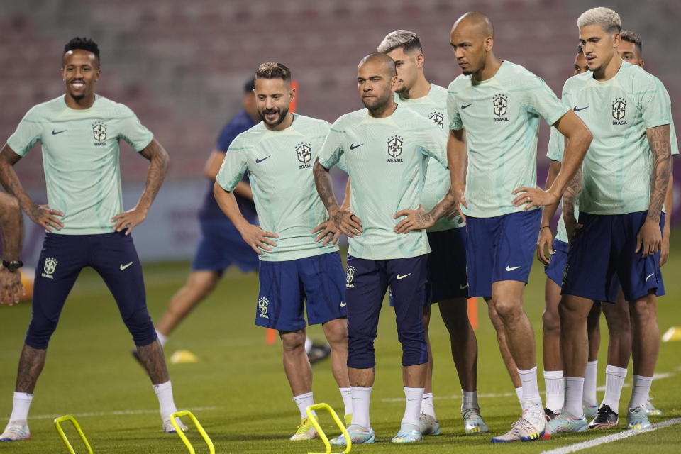 Brazil's Dani Alves, center, and teammates exercise during a training session at the Grand Hamad stadium in Doha, Qatar, Thursday, Dec. 1, 2022. Brazil will face Cameroon in a group G World Cup soccer match on Dec. 2. (AP Photo/Andre Penner)