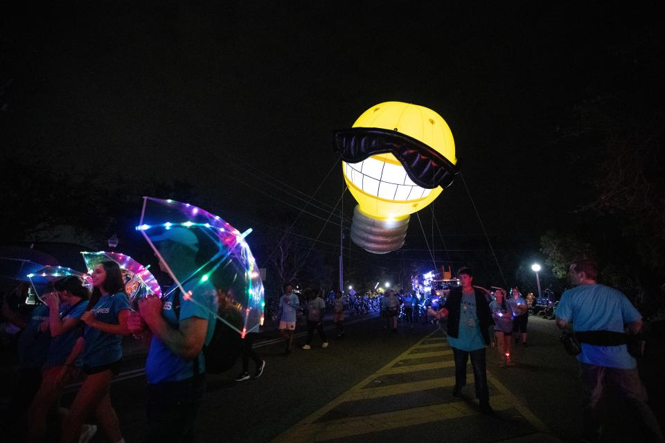 The LCEC light bulb balloon comes down Cortez Boulevard at the start of the Edison Festival of Light Grand Parade on Saturday, Feb. 17, 2024, in Fort Myers.