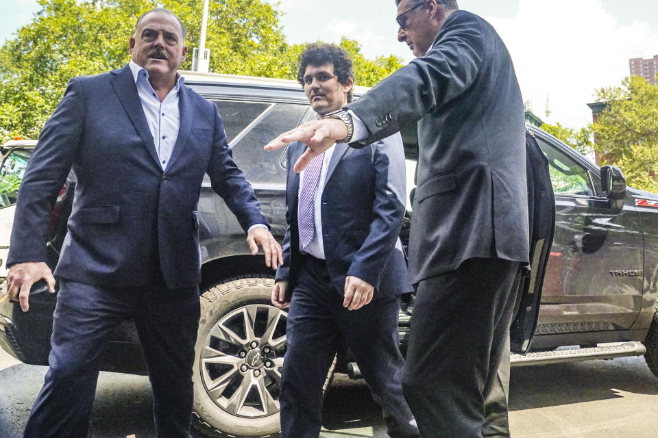 FTX founder Sam Bankman-Fried, center, arrives at Manhattan federal court, Friday Aug. 11, 2023, in New York. Bankman-Fried is returning to New York City for a court hearing Friday that could decide whether the fallen cryptocurrency wiz must go to jail while he awaits trial. (AP Photo/Bebeto Matthews)