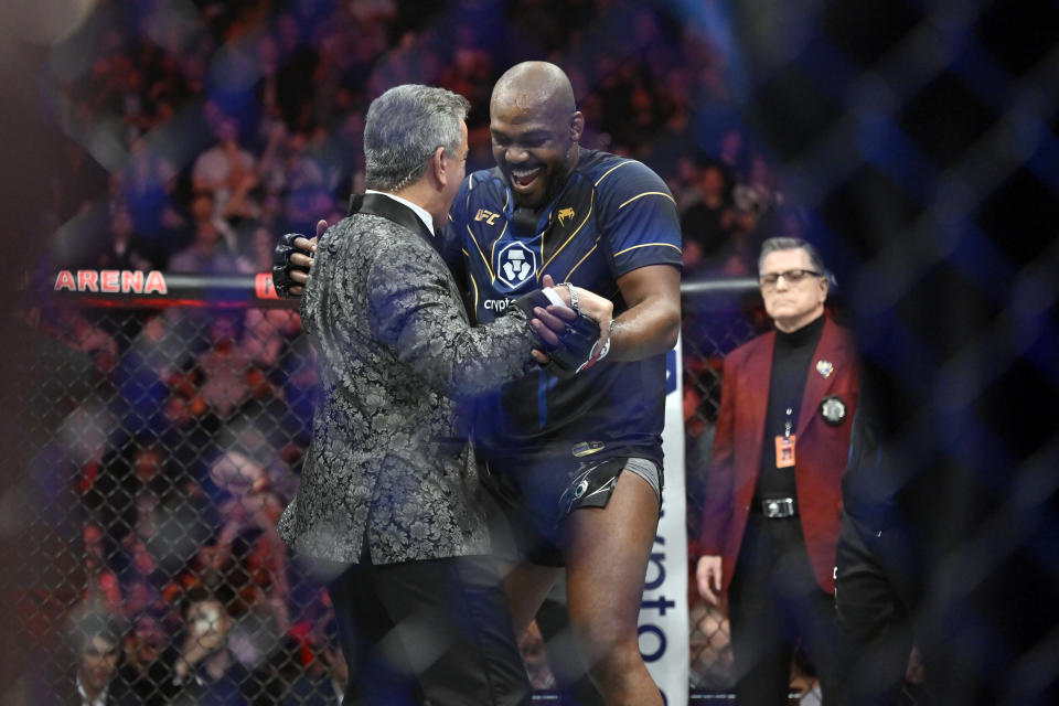 Jon Jones, right, dances with announcer Bruce Buffer after defeating Ciryl Gane in a UFC 285 mixed martial arts heavyweight title bout Saturday, March 4, 2023, in Las Vegas. (AP Photo/David Becker)