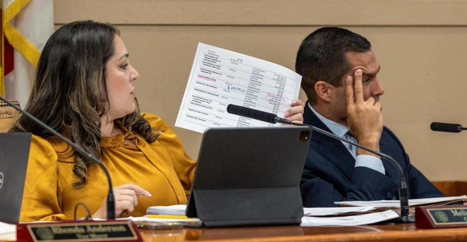 With Mayor Vince Lago, right, sitting next to her, Coral Gables Commissioner Melissa Castro shows a document with details about Mayor Vince Lago’s PAC during the Sept. 13, 2023 commission meeting at Coral Gables City Hall.