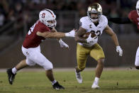 Notre Dame's Kyren Williams, right, runs against Stanford's Lance Keneley , left, during the first half of an NCAA college football game in Stanford, Calif., Saturday, Nov. 27, 2021. (AP Photo/Jed Jacobsohn)