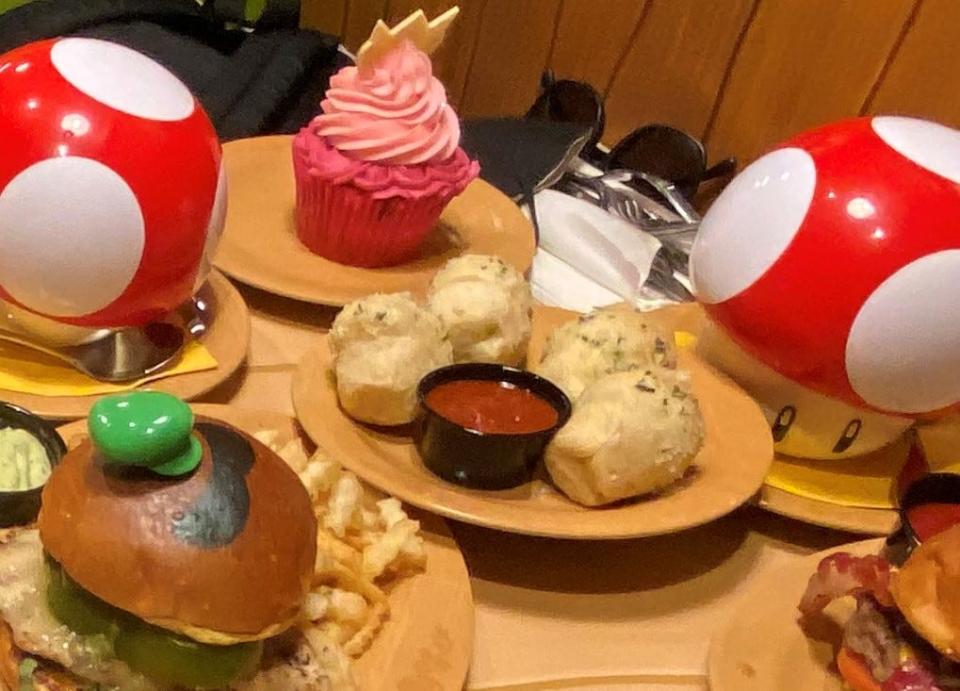 Four garlic knots sit among a feast at Super Nintendo World's Toadstool Cafe, which is inside Universal Studios Hollywood in Southern California.