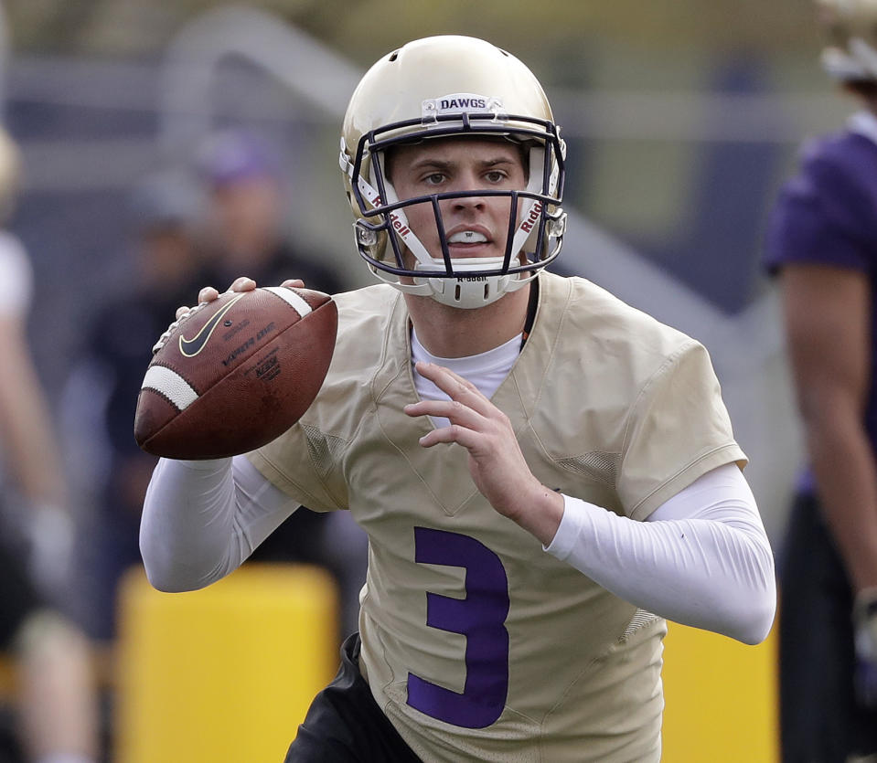 FILE - In this March 28, 2018, file photo, Washington quarterback Jake Browning looks to pass during an NCAA college football practice, in Seattle. Potential Heisman Trophy contender Browning will lead No. 6 Washington against No. 9 Auburn in the only opening-week game between top-10 teams. (AP Photo/Elaine Thompson, File)