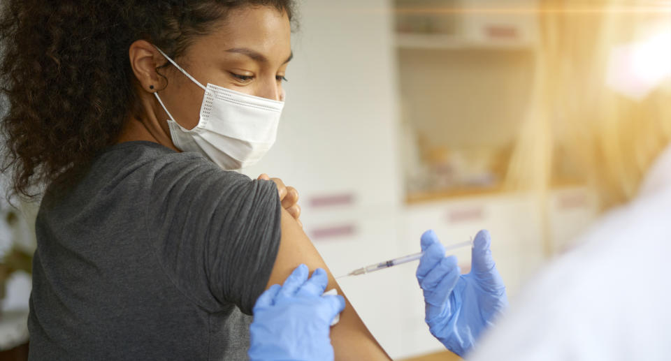 A woman receives a vaccination