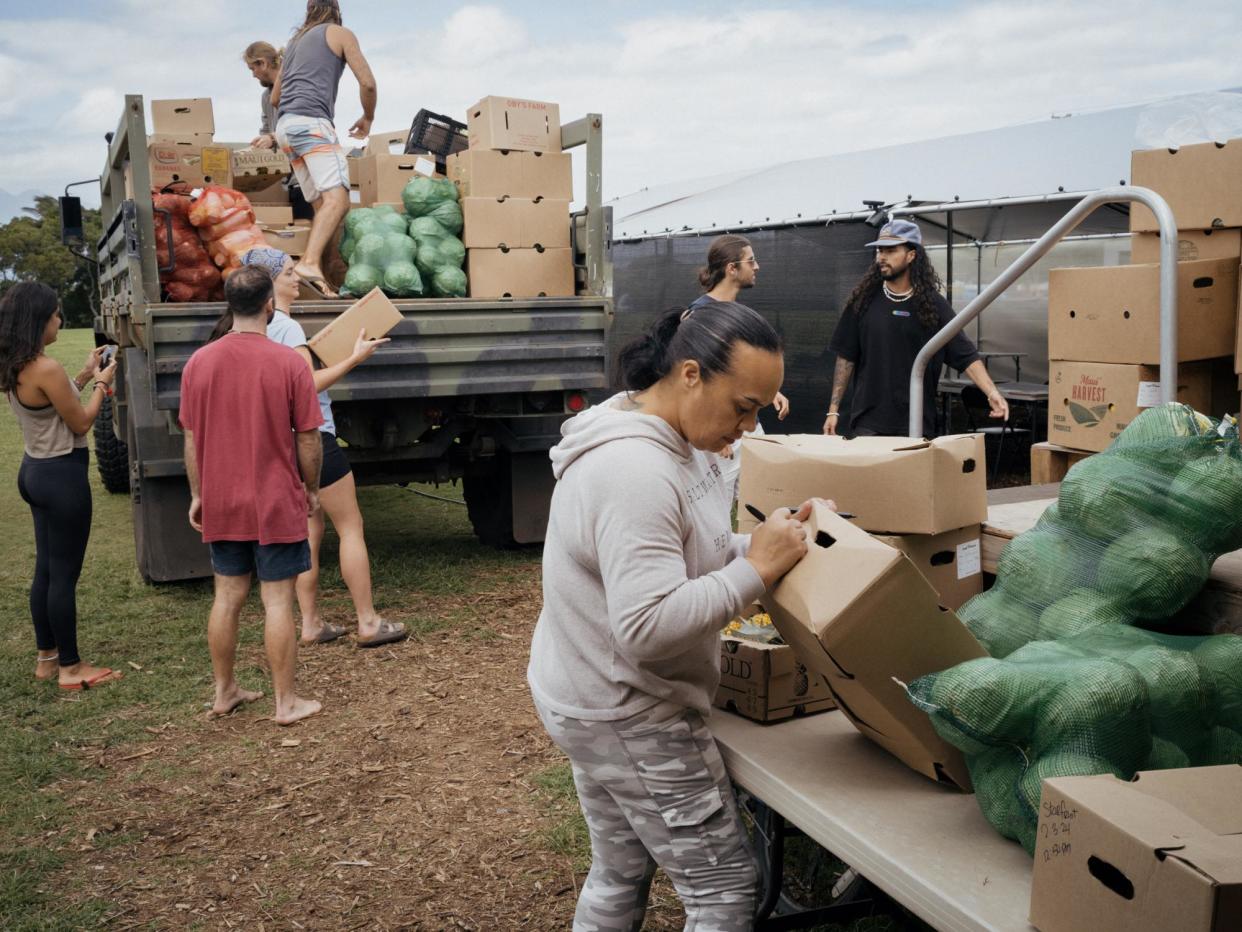 <span>Unloading a fresh produce delivery at Nāpili Park Emergency Community Resource Center.</span><span>Photograph: Phil Jung/The Guardian</span>
