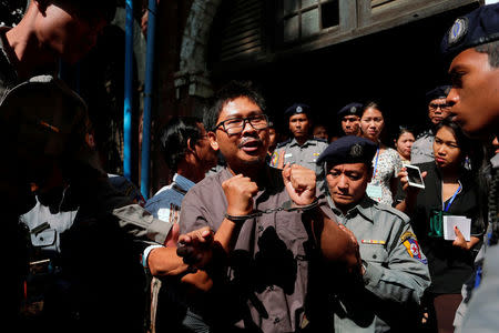 Detained Reuters journalist Wa Lone is escorted by police after a court hearing in Yangon, Myanmar March 7, 2018. REUTERS/Stringer