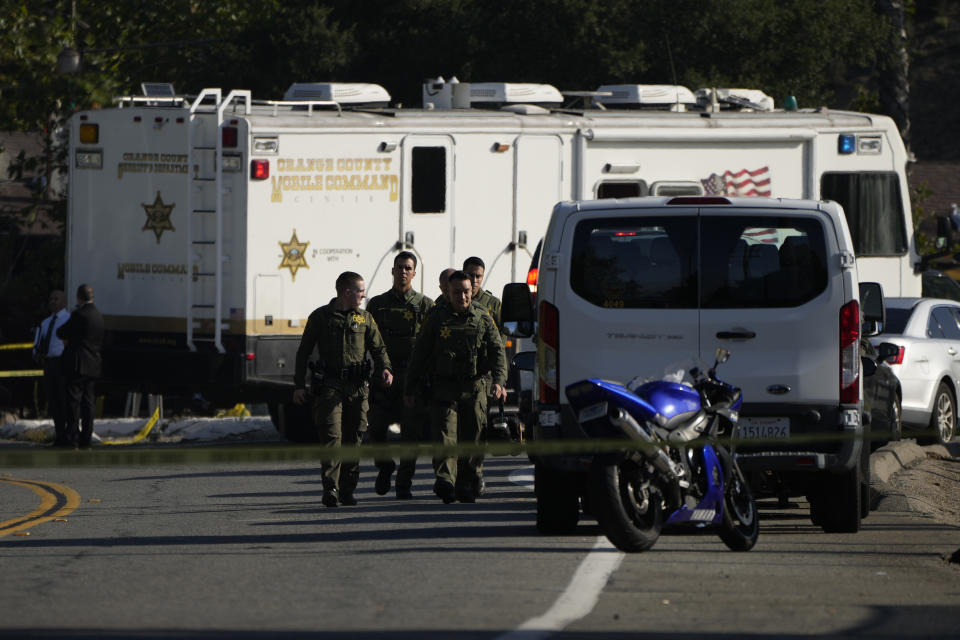 CAPTION CORRECTION: CORRECTS NAME OF BAR: Law enforcement personnel stage at the scene of a mass shooting outside Cook's Corner, Thursday, Aug. 24, 2023, in Trabuco Canyon, Calif. Gunfire at a popular Southern California biker bar killed three people and wounded several others Wednesday, and the gunman — believed to be a retired law enforcement officer — was fatally shot by deputies, authorities said. (AP Photo/Jae C. Hong)