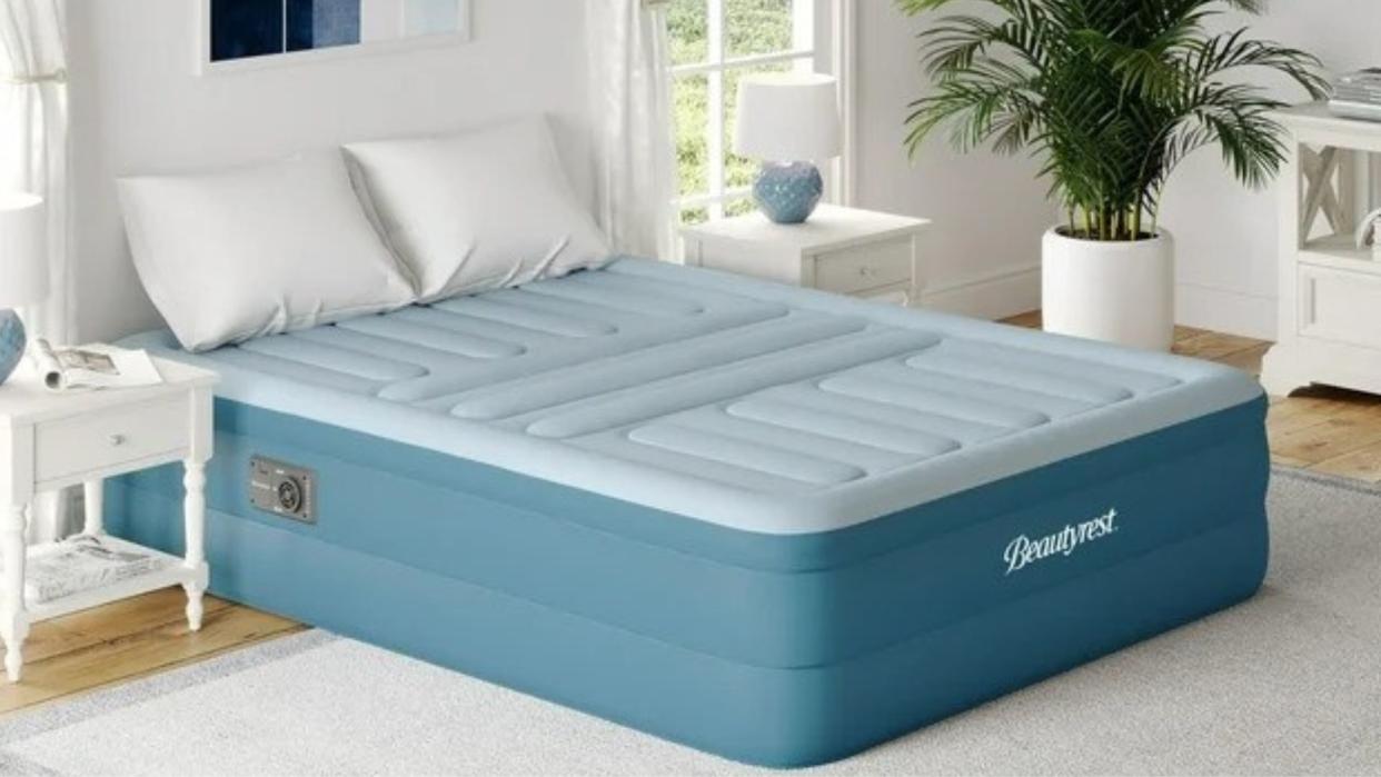  Beautyrest air mattress placed on the floor in a light, bright bedroom. 