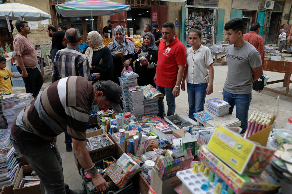 People shop for school supplies in preparation for the new school year, in Baghdad, Iraq, Sunday, Oct. 31, 2021. Across Iraq, students returned to classrooms Monday for the first time in a year and a half – a stoppage caused by the coronavirus pandemic - amid overcrowding and confusion about COVID-19 safety measures. (AP Photo/Khalid Mohammed)