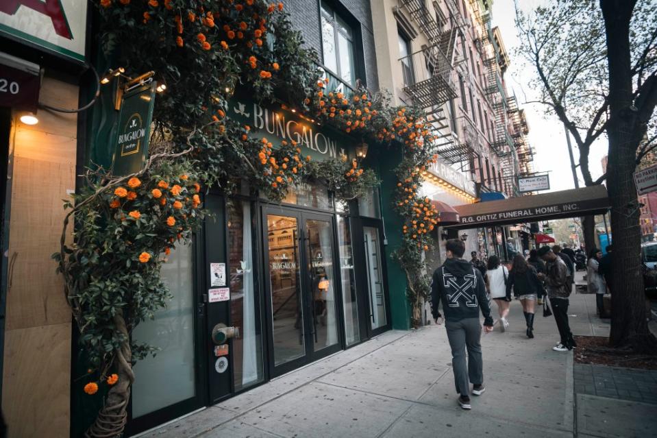 The unassuming neighborhood businesses stand in stark contrast to the elegance diners find when they step through Bungalow’s flower-covered doors. Stefano Giovannini
