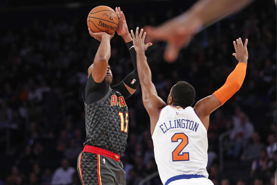 Atlanta Hawks guard Vince Carter (15) shoots as New York Knicks guard Wayne Ellington (2) defends during the first half of a preseason NBA basketball game in New York, Wednesday, Oct. 16, 2019. (AP Photo/Kathy Willens)