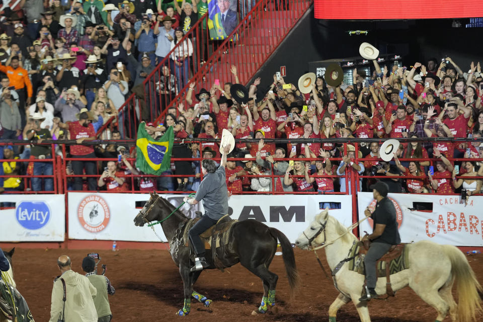 Brazilian President Jair Bolsonaro, who is running for a second term, rides a horse at the the Barretos Rodeo International Festival in Barretos, Sao Paulo state Brazil, Friday, Aug. 26, 2022. Brazil's general elections are scheduled for Oct. 2, 2022. (AP Photo/Andre Penner)