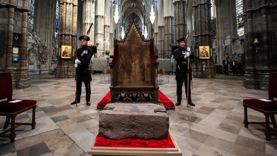 King's Bodyguards for Scotland and members of Royal Company of Archers Alex Baillie-Hamilton (L) and Paul Harkness (R) stand guard by the Stone of Destiny Westminster Abbey in central London on April 29, 2023 during a welcome ceremony. - The stone, an ancient symbol of Scotland's monarchy, will play a central role in the Coronation of The King in the Abbey on Saturday 6th May. In 1296, King Edward I brought the stone to Westminster. He placed it within the Coronation Chair, the oak seat he commissioned in 1300-1301 and which has been the centre piece of coronations for more than 700 years. In 1996, the UK government announced that the stone would return to Scotland, but would come back to the Abbey for coronations. (Photo by Susannah Ireland / POOL / AFP)