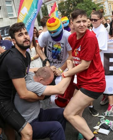 Participants of the Equality March, organized by the LGBT community, scuffle with a man attempting to break their march in Kiev