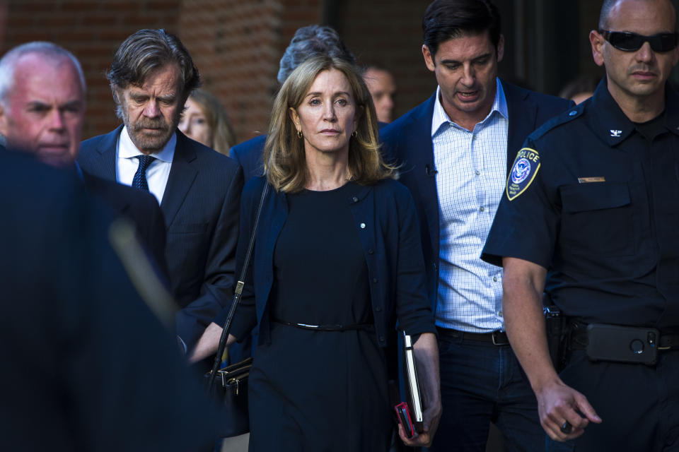 Felicity Huffman, with William H. Macy, leaves court after being sentenced. (Photo: Nic Antaya for the Boston Globe via Getty Images)