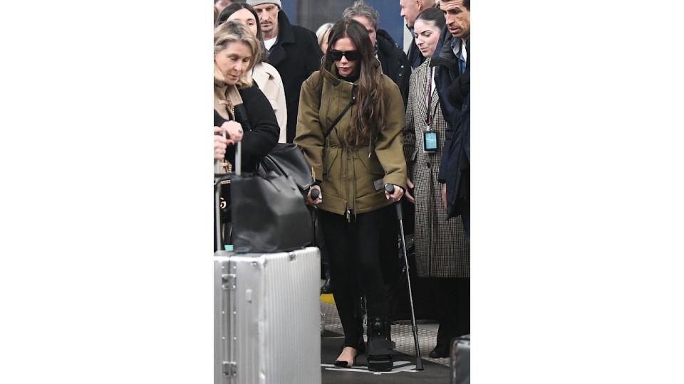 Victoria Beckham in Paris in a khaki cinched coat