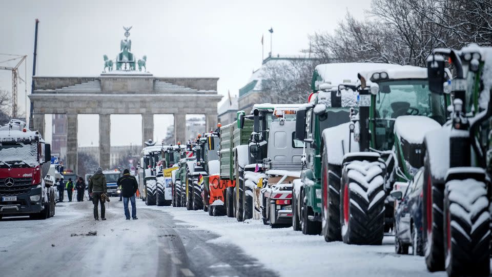 Farmers with tractors protest at the Brandenburg Gate in Berlin, Germany. - Kay Nietfeld/dpa via AP