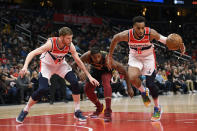 Washington Wizards forwards Troy Brown Jr. (6) and Davis Bertans (42) chase the ball next to Cleveland Cavaliers center Tristan Thompson (13) during the first half of an NBA basketball game Friday, Feb. 21, 2020, in Washington. (AP Photo/Nick Wass)