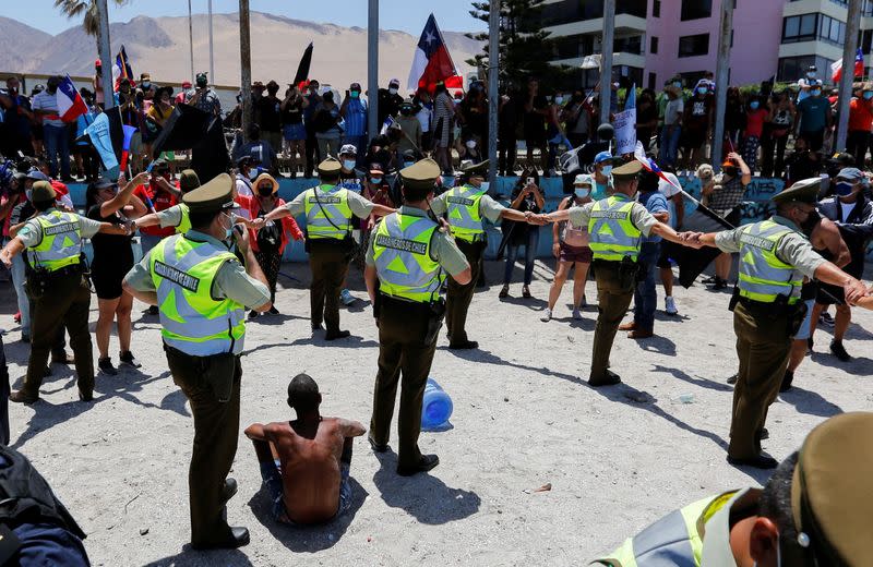 Chileans take part in a rally against migrants and delinquency, in Iquique