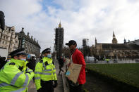 LONDON - UNITED KINGDOM - JANUARY 6: British police stand near a demonstrator protesting government's lockdown decision imposed to stem coronavirus (Covid-19) pandemic outside the House of Commons in London, United Kingdom on January 6, 2021. (Photo by Tayfun Salci/Anadolu Agency via Getty Images)