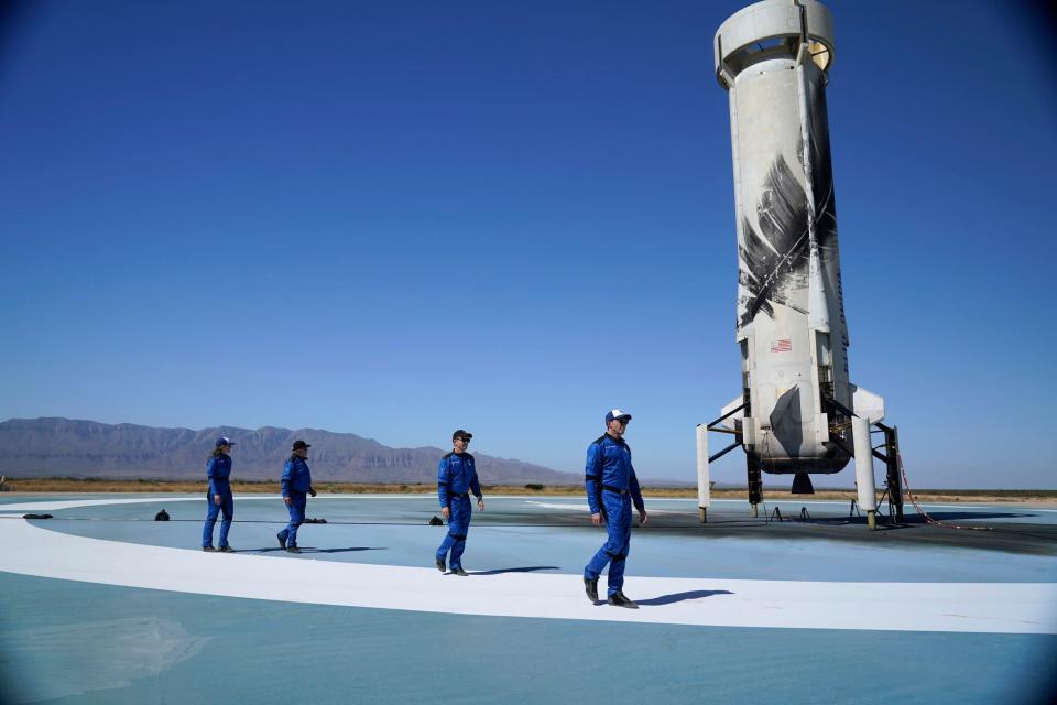 Blue Origin's New Shepard rocket latest space passengers from right Glen de Vries, right, Chris Boshuizen, William Shatner and Audrey Powers walk on the booster rocker landing pad for a media availability at the spaceport near Van Horn, Texas, Wednesday, Oct. 13, 2021.