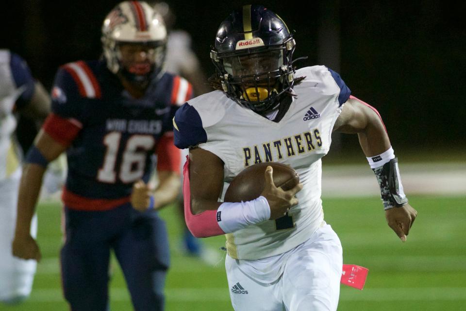 St. John Paul II junior quarterback Tremaine Hughes Jr. (1) runs the ball in a game against Wakulla on Oct. 7, 2022, at Wakulla High School. The War Eagles won, 39-36.