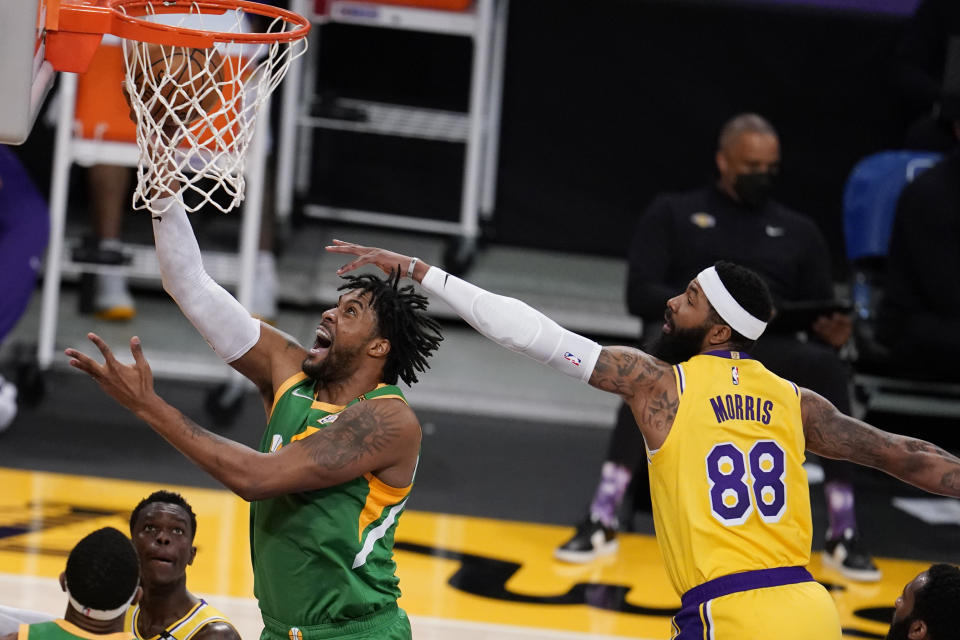 Utah Jazz center Derrick Favors, left, drives past Los Angeles Lakers forward Markieff Morris, right, during the first half of an NBA basketball game Monday, April 19, 2021, in Los Angeles. (AP Photo/Marcio Jose Sanchez)