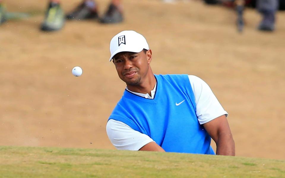 Tiger Woods escapes the bunker during the first round - Action Plus